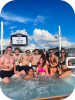 a group of people on a hot tub boat posing for the camera