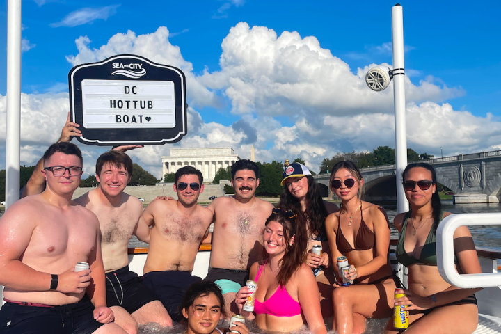 a group of people on a hot tub boat posing for the camera