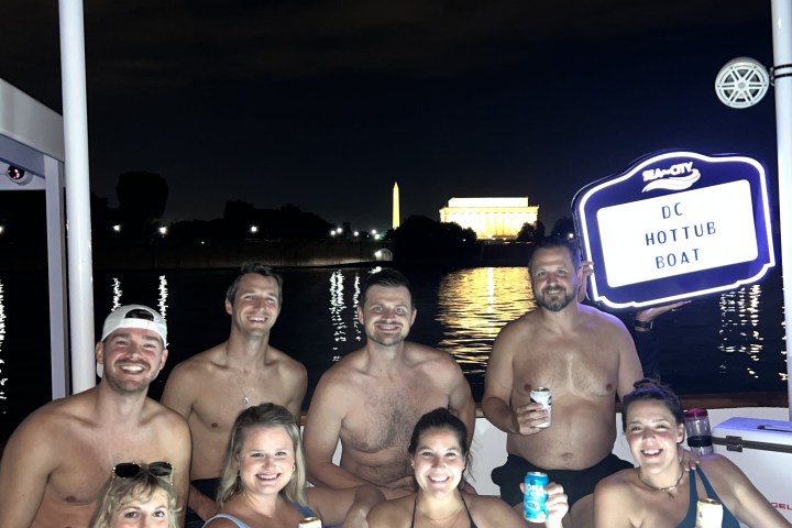 group of people enjoying the DC hot tub boat at night