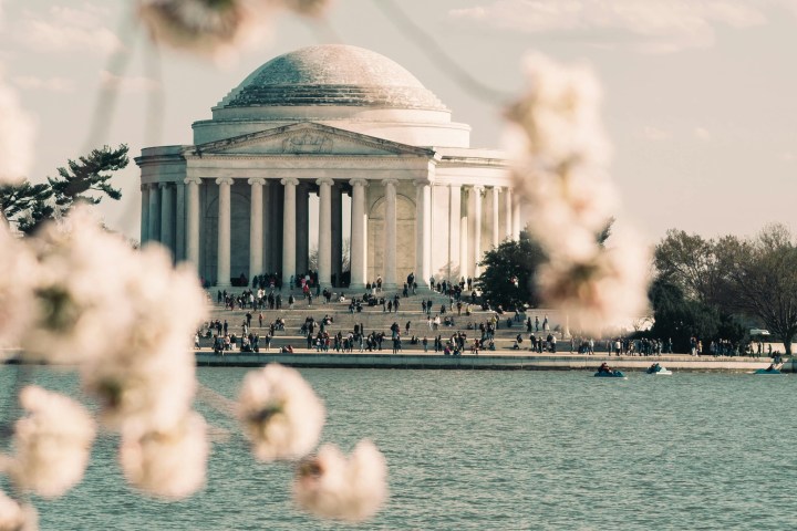 a small boat in a body of water with smoke coming out of it