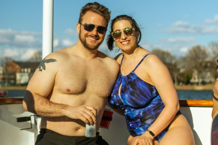 a man and a woman standing in front of water