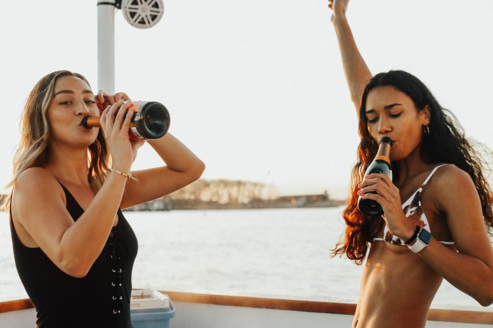 a woman standing next to a body of water